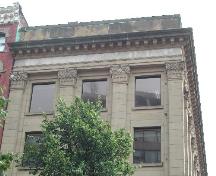 This photograph shows the upper storey windows, corinthian columns and cornice, 2004; City of Saint John