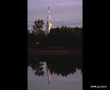 The spire of St. Bigid's RC Church reflecting the nearby water; Province of PEI