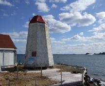 This photograph shows the contextual view of the lighthouse, 2007; Town of St. Andrews