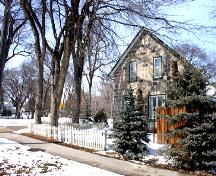 View looking across wooded lot, of the McElroy House, Morden, 2005; Historic Resources Branch, Manitoba Culture, Heritage and Tourism, 2005