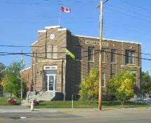 View of the front façades, featuring the entryway, clock and pilasters; Government of Saskatchewan, Brett Quiring, 2006.