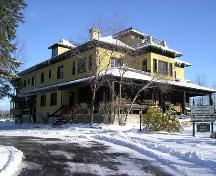Front of chateau showing  log columns and wall; OHT, 2006