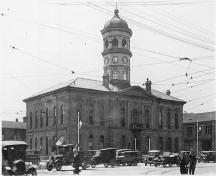 View of facade showing second clock tower added in 1865 and heightened in 1870 - c.1920; Archives of Ontario