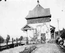 C.N. Rail Station with lawn and flowers in the foreground, circa 1920.; Township of Langley, Serial No.1043
