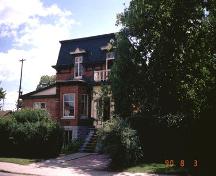 Charming mid-1870s home features original porch with panelled doors, decorated dormer windows above; City of Ottawa 2005