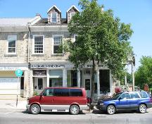 View of main (south) facade showing ground floor storefronts and attic level dormers – August 2004; Sawchuck, 2004