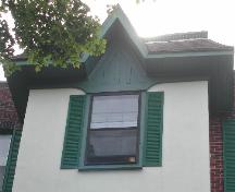This image provides a view of the hipped roof with gable detail crowning the central bay, 2005.; City of Saint John