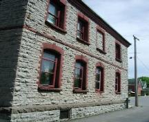 The western view of the Mississippi Valley Textile Mill, showcasing its sandstone exterior – 2003; OHT, 2003