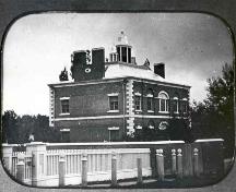 View of the front of the house including original fence and garden; Archives of Ontario