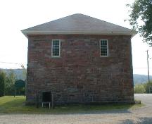This image displays the cut stone, broken course walls made of red sandstone.; PNB 2004