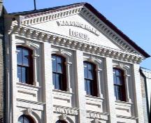 Third storey featuring segmentally arched windows and date stone, 2004.; City of Brantford, Department of Planning, 2004.