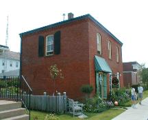 This image shows an angled view of the front façade and a side elevation, looking south, 2007.; Province of New Brunswick