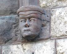 Detail of a sculpted head adjacent to one of the doors on the Peck Building, Winnipeg, 2005; Historic Resources Branch, Manitoba Culture, Heritage, Tourism and Sport, 2005