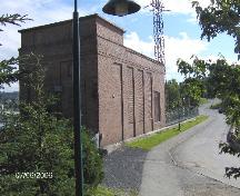 Photo of the left side of the hydroelectric generating station, taken from Ferry Avenue near Emmerson House; Madawaska Historical Society