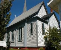 This image shows three of the four sets of double Italianate windows along the side of the building.; PNB 2005