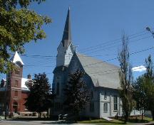 This image of the church illustrates its Neo-Gothic and Italianate stylistic features demonstrating transitional design forms including a well articulated three-step tower with applied corner buttresses, and a closed belfry with octagonal steeple.; PNB 2005