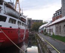 General view of the Kingston Dry Dock, showing the long, rectangular dock with 9.1 metres high stepped sides, 2008.; Agence Parcs Canada / Parks Canada Agency, David Henderson, 2008.