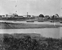 General view of Moose Factory, showing the Staff House at the left of the image, circa 1870.; Library and Archives Canada / Bibliothèque et Archives Canada, C-001718.