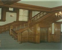View of the staircase from the main floor foyer – 1993; OHT, 1993