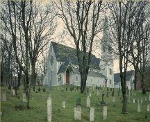 General view of the Trinity Anglican Church, showing the choice of medieval architectural details, such as the pointed windows, 1991.; Parks Canada Agency / Agence Parcs Canada, 1991.