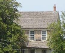 Of note are the 8 over 12 windows and the stone chimney.; Kayla Jonas, 2007.