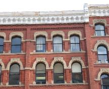 This photograph shows the pointed arch, segmented arch and Roman arch windows, as well as the decorative cornice, 2004; City of Saint John