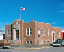 Front and side of Wadena Town Office featuring its decorative front entry way, 1987.; Government of Saskatchewan, F. Korvemaker, 1987