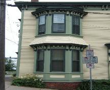 This photograph shows the semi-octagonal bay window, with brackets under each storey's cornice, 2005; City of Saint John