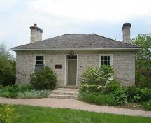 Featured is the hip roof with two double and jointed stone chimneys.; Kayla Jonas, 2007.