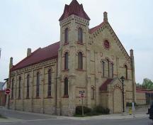 Of note is the pyramidal-roofed tower and detailing along the roofline.; Kayla Jonas, 2007.
