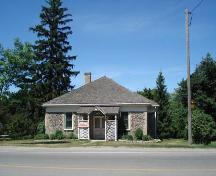 Of note are the hip roof, cobblestone construction and small entrance portico.; Kendra Green, 2007.