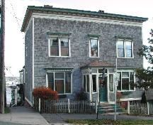 This photograph shows the contextual view of the building facing on Pitt Street with Orange Street and Courtney Bay in the background, 2005; City of Saint John