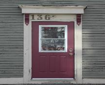 This photograph shows the entrance to the building with a bracketed entablature, 2005; City of Saint John
