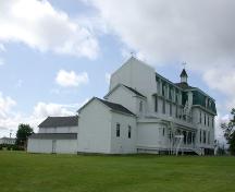 Rear view of the building illustrates the clapboard-covered exterior and the mansard roof with dormer windows.; PNB 2005