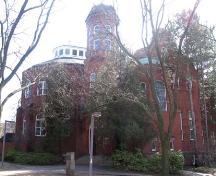 The south elevation includes a false front, partially covered by the trees.; Lindsay Benjamin, 2007.