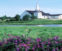 View of the exterior of Tryon United Church, showing its picturesque setting on the river bank, 1995.; Parks Canada Agency / Agence Parcs Canada, J. Butterill, 1995.
