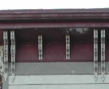 This image provides a view of the cornice supported by a series of wooden, scroll brackets, 2006; City of Saint John
