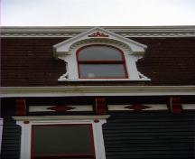 Detail of bonnetted dormer window and diamond-pattern eave moulding.  Date unknown.; HFNL 2007