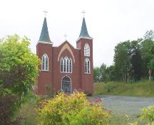 View looking west of Immaculate Conception Church and Grounds, Cape Broyle, NL. Photo taken July 2006. ; HFNL/Andrea O'Brien 2006