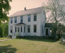 View of the main entrance to the rectory, showing its two-storey, rectangular form with a central doorway.; Parks Canada Agency/ Agence Parcs Canada.