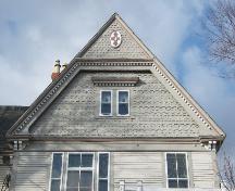 This photograph shows the ornate gable with fancy shingling and insignia near the peak, 2006; City of Saint John