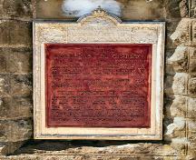 This image shows a close-up of the plaque, respecting the accepted design of the Historic Sites and Monuments Board of Canada, 2009; Village of Minto