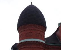 One of the distinguishing Romanesque Revival elements that remains intact on the Peters House is the red brick 'beehive' turret over the main entrance.; Moncton Museum