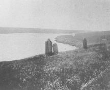 View of stones standing near bank, c 1970; PEI PARO P0002994 - Cemetery Files/21-9/P-1