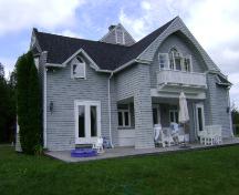 This photograph shows the ocean front façade. It illustrates the gabled projection that serves as a covered veranda, as well as a covered balcony in upper level, 2007; Town of St. Andrews