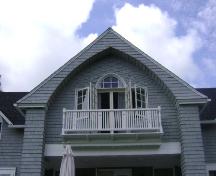 This photograph shows the master bedroom balcony and the recessed Gothic arch that serves as a balcony cover.  It also illustrates fancy cut shingling, 2007; Town of St. Andrews