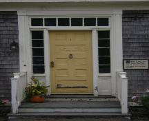 This photograph shows the wood door, transom window and sidelights, 2007; Town of St. Andrews