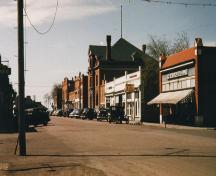 Archival view, from the northeast, of the Charlie Sear Building (last tall building in the row), Carberry, ca. 1945; Carberry Plains Archives, ca. 1945