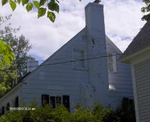 This photograph shows the side façade with end chimney, 2009; Town of St. Andrews