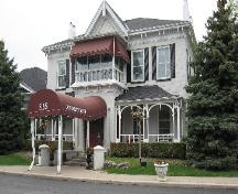 Featured is the striking facade of painted white brick complemented by 6 over 6 paned windows.; Chelsey Tyers, 2008.